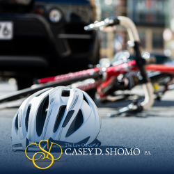 A bike and helmet lie on the ground following a West Palm Beach bicycle accident