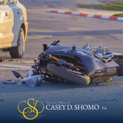 A motorcycle on its side and debris in the road after a motorcycle accident in WEst Palm Beach